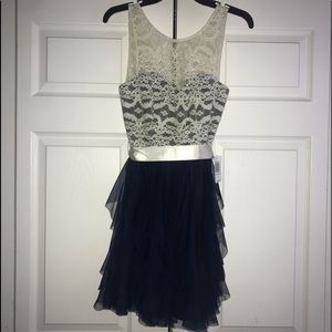 Sleeveless lace illusion top corkscrew dress